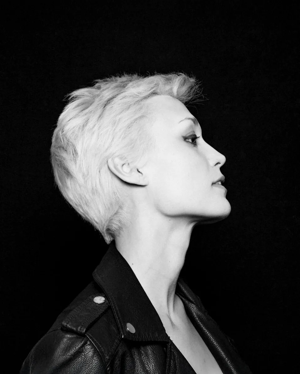 Dramatic black and white portrait series of actor Deborah Muriel Blum with short platinum hair, showcasing dynamic profile poses